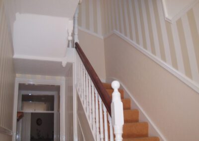 Wallpapering and painting of a hallway and stairs